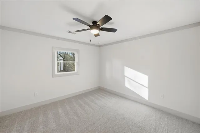a kitchen with a refrigerator and white cabinets