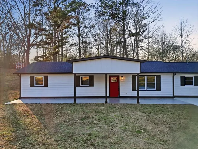 a couple of cars parked in front of a house