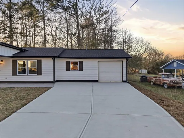 a house that has a tree in front of it