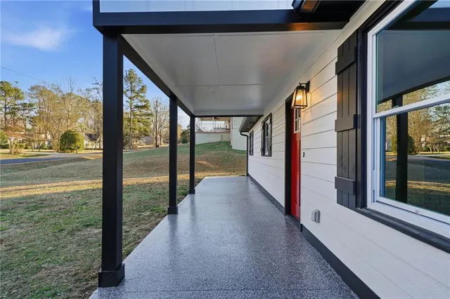 a front view of house with yard and trees around
