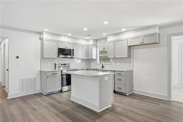 a kitchen with a white cabinets and refrigerator