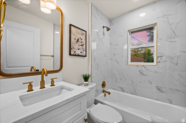 189 West Center Street Midvale, UT 84047 - Photo 23 of 64 Bathroom featuring white marble-look wall tiling, a gold-framed mirror, and a vanity with a white countertop and integrated sink