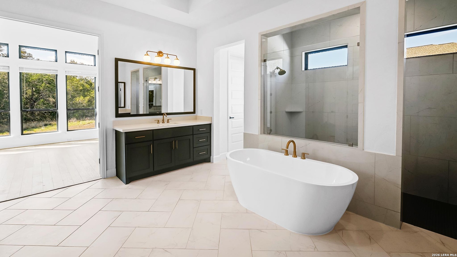 1006 Rapidan Lane Bulverde, TX 78163 - Photo 24 of 26 a spacious bathroom with a tub sink and mirror