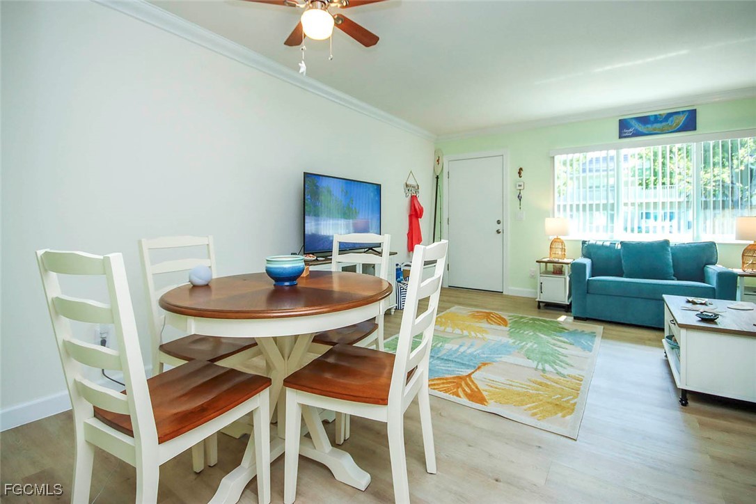 641 Periwinkle Way, Unit A3 Sanibel, FL 33957 - Photo 11 of 26 a living room with furniture a rug potted plant and a window