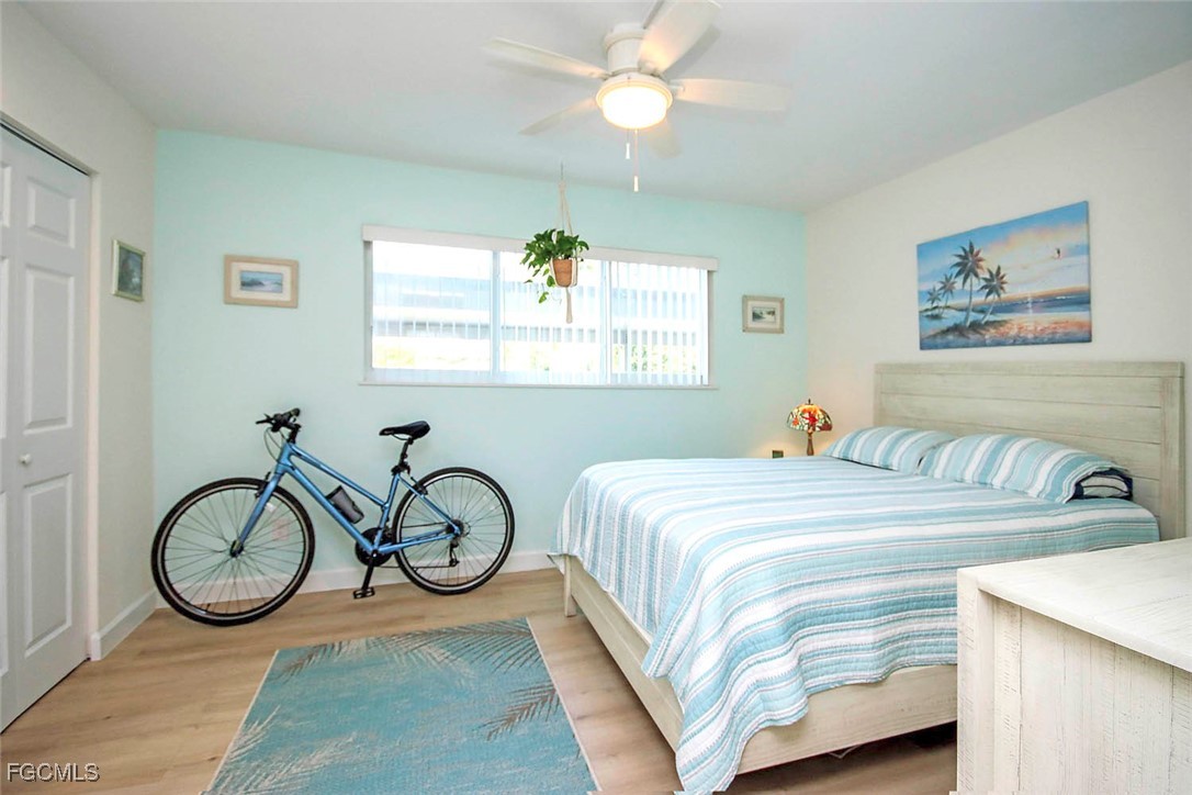 641 Periwinkle Way, Unit A3 Sanibel, FL 33957 - Photo 15 of 26 a bedroom with a bed and a chandelier