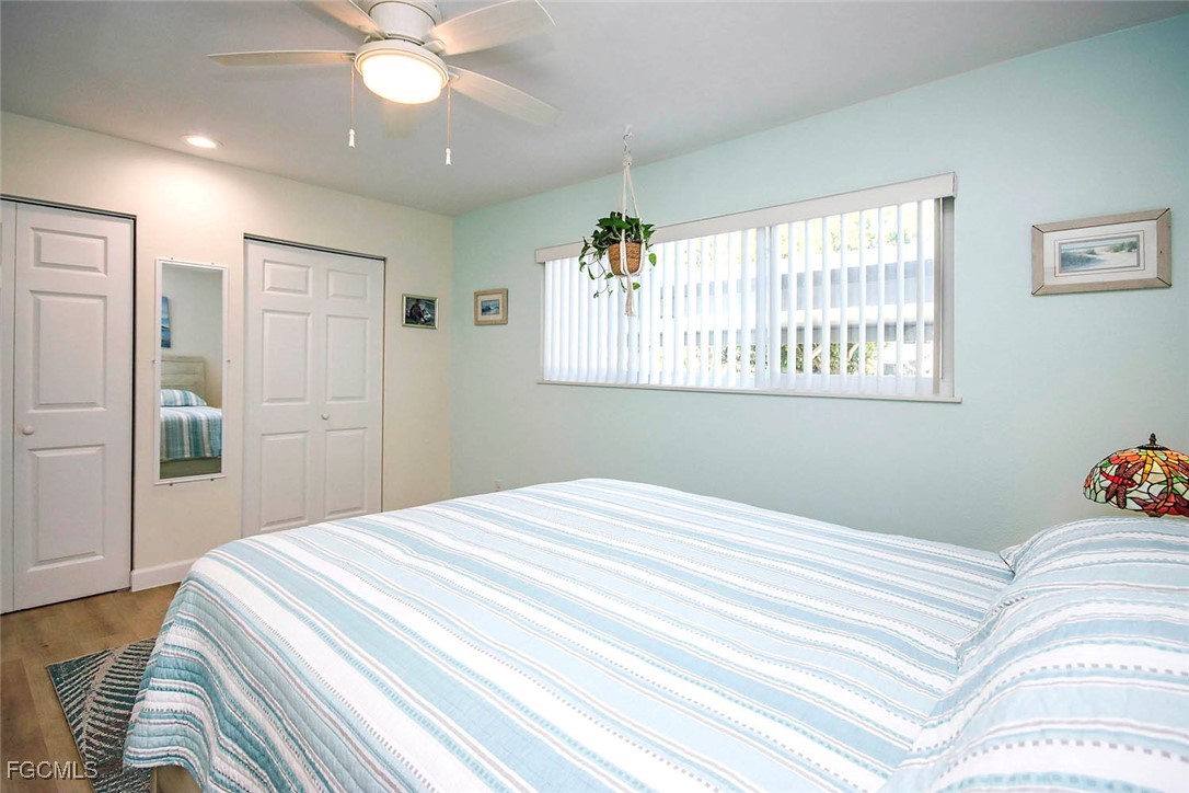 641 Periwinkle Way, Unit A3 Sanibel, FL 33957 - Photo 16 of 26 a bedroom with a large bed and a chandelier