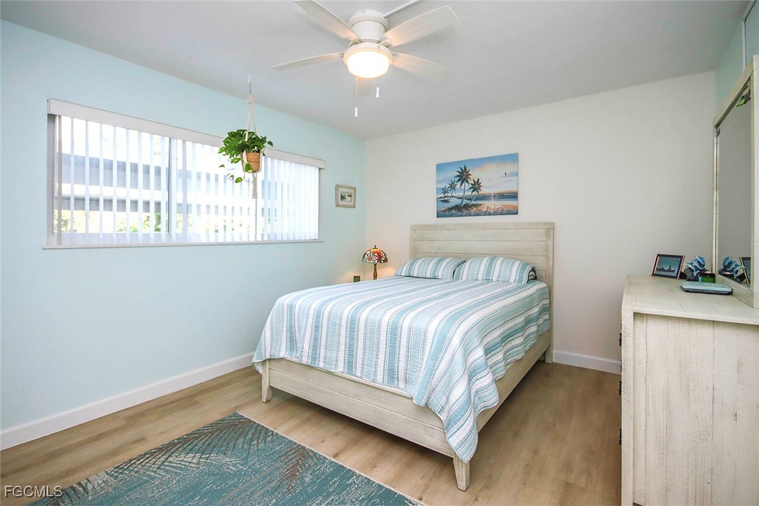 641 Periwinkle Way, Unit A3 Sanibel, FL 33957 - Photo 17 of 26 a bedroom with a bed and a window
