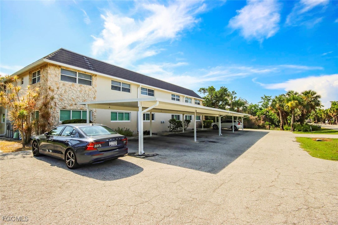 641 Periwinkle Way, Unit A3 Sanibel, FL 33957 - Photo 19 of 26 a car parked in front of a house