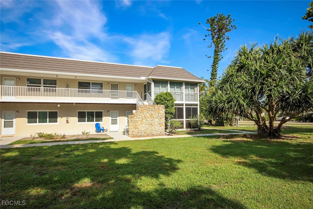 641 Periwinkle Way, Unit A3 Sanibel, FL 33957 - Photo 24 of 26 a front view of a house with a garden