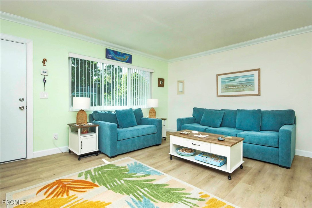 641 Periwinkle Way, Unit A3 Sanibel, FL 33957 - Photo 4 of 26 a living room with furniture and a rug