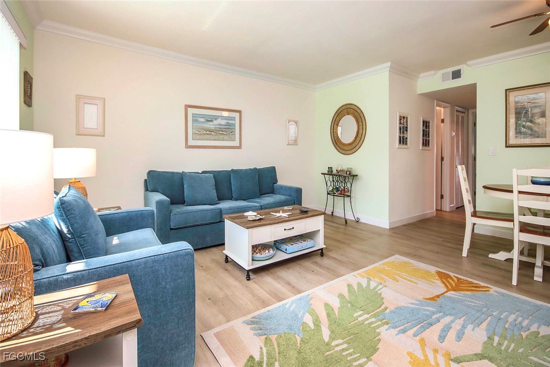 641 Periwinkle Way, Unit A3 Sanibel, FL 33957 - Photo 5 of 26 a living room with furniture and a wooden floor