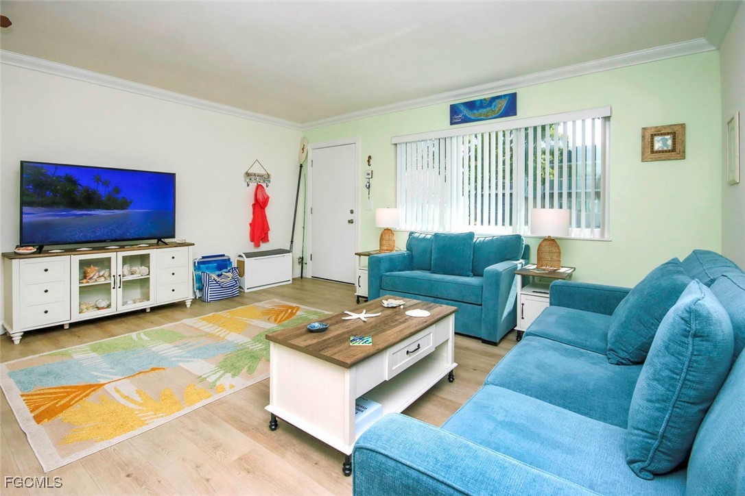 641 Periwinkle Way, Unit A3 Sanibel, FL 33957 - Photo 6 of 26 a living room with furniture and a flat screen tv