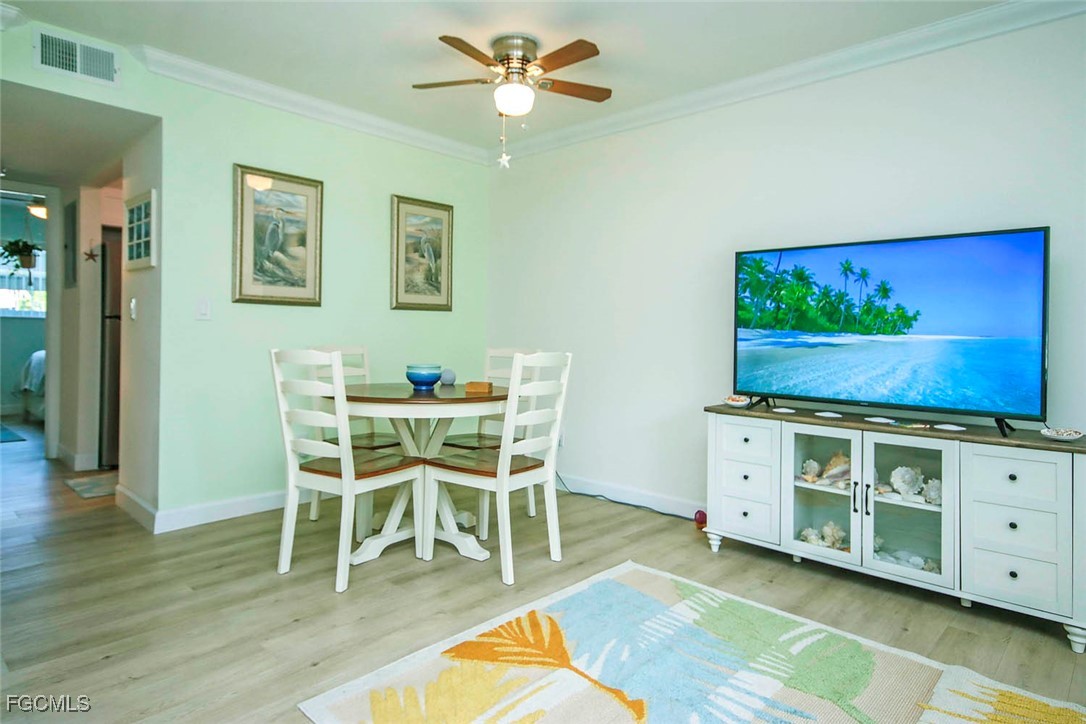 641 Periwinkle Way, Unit A3 Sanibel, FL 33957 - Photo 8 of 26 a dining room with furniture and wooden floor