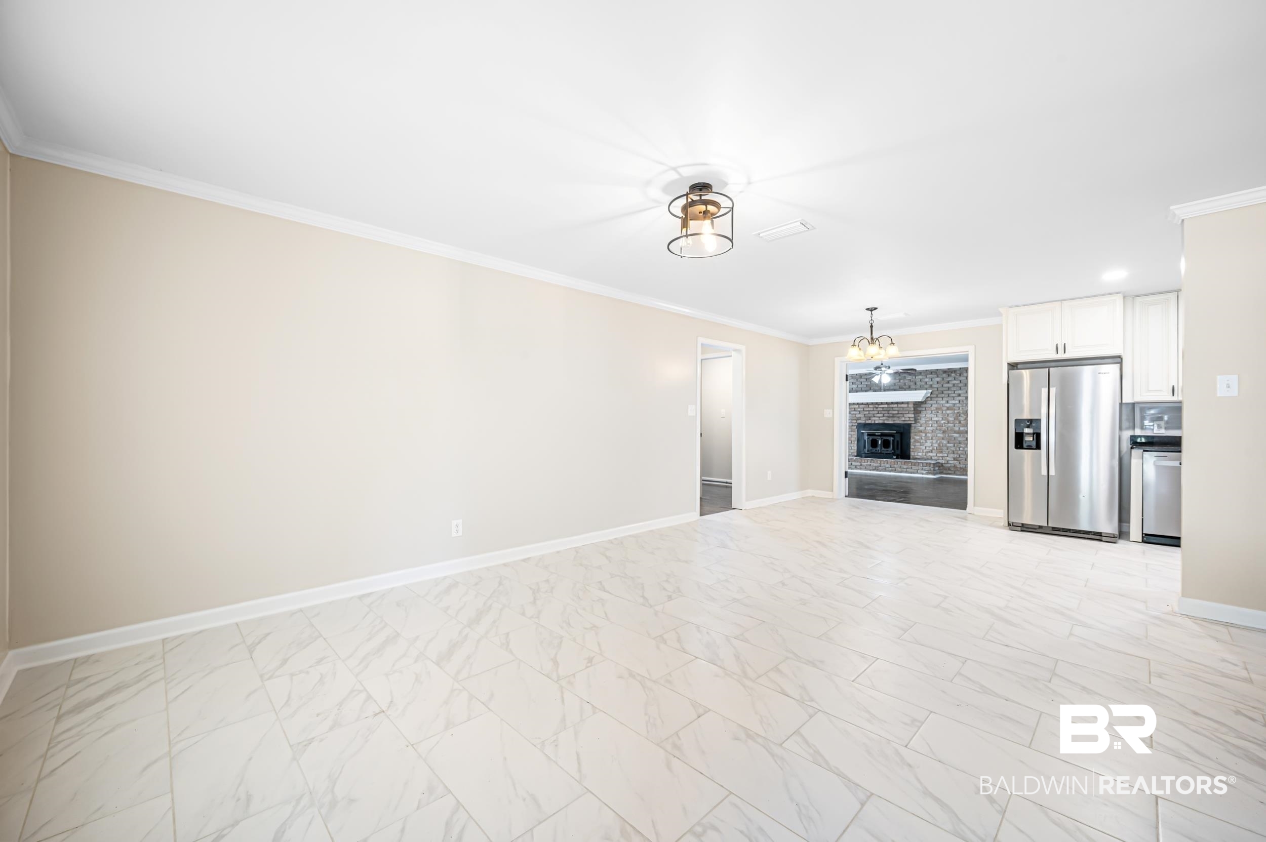 1605 Collier Avenue Bay Minette, AL 36507 - Photo 8 of 36 Unfurnished living room with ornamental molding, a brick fireplace, and light marble finish floors