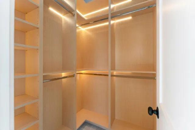 a bathroom with a double vanity sink toilet and shower