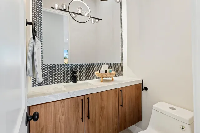 a bedroom with a bed and painting on the wall