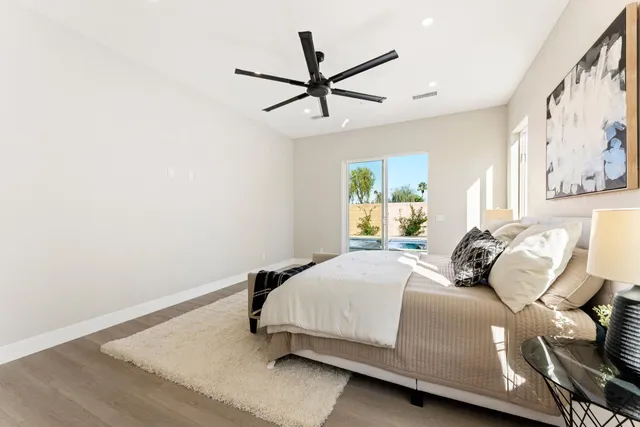 a living room with furniture kitchen view and a chandelier