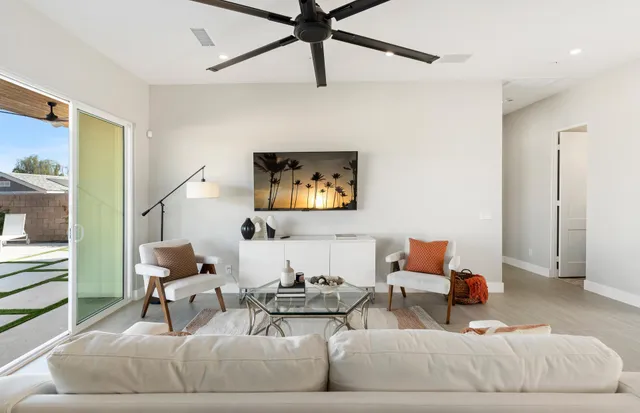 a living room with furniture pool table and chairs