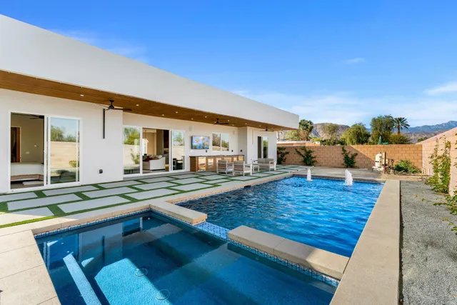 a large kitchen with stainless steel appliances granite countertop a lot of counter space and a sink
