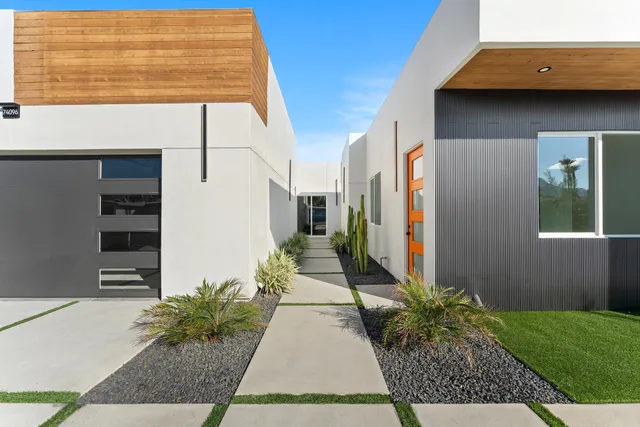 a view of a hallway with wooden floor and a living room