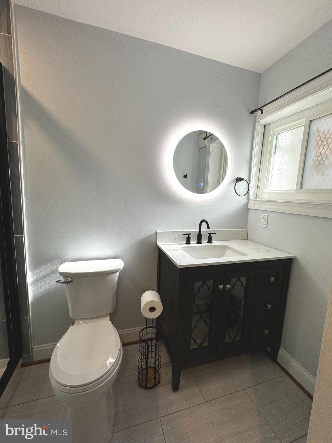 3208 Auchentoroly Terrace Baltimore, MD 21217 - Photo 18 of 25 a bathroom with a toilet sink and mirror
