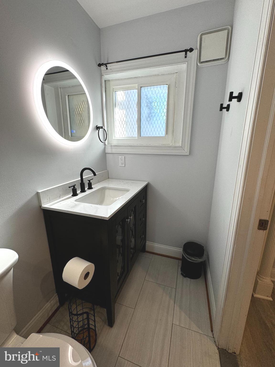 3208 Auchentoroly Terrace Baltimore, MD 21217 - Photo 20 of 25 a bathroom with a sink a toilet and a mirror
