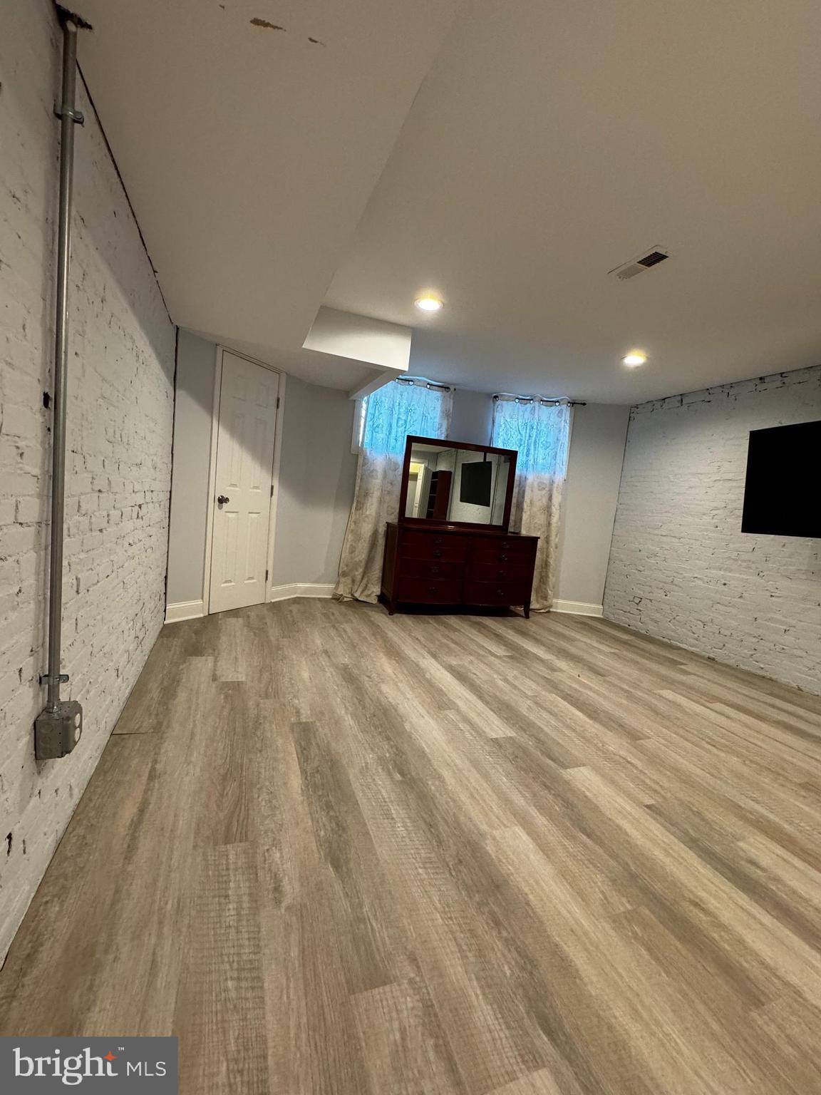 3208 Auchentoroly Terrace Baltimore, MD 21217 - Photo 24 of 25 a large room with wooden floor and windows