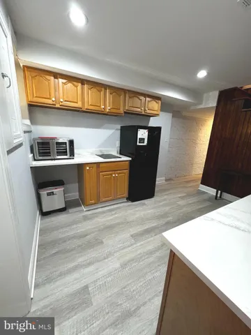 a kitchen with kitchen island a stove and a sink