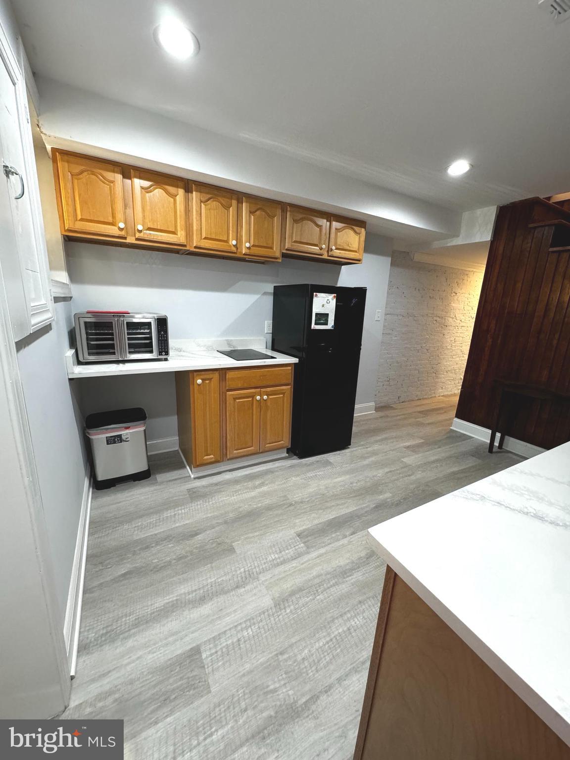 3208 Auchentoroly Terrace Baltimore, MD 21217 - Photo 4 of 25 a kitchen with kitchen island a stove and a sink