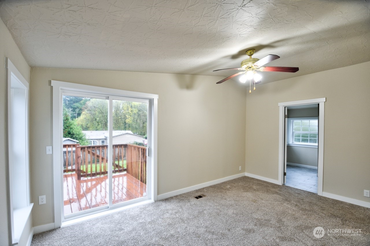 27 South Gee Creek Loop Ridgefield, WA 98642 - Photo 17 of 26 wooden floor in an empty room with a window