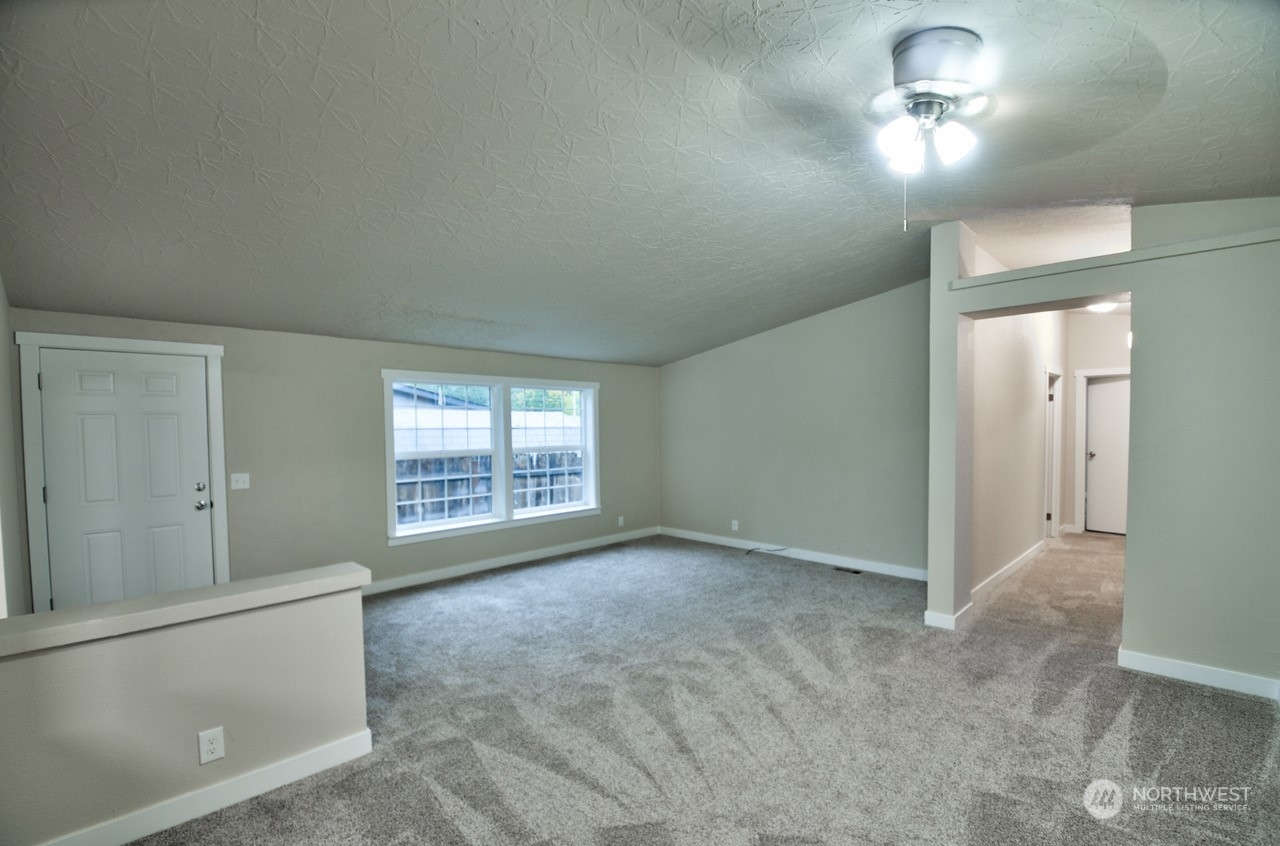 27 South Gee Creek Loop Ridgefield, WA 98642 - Photo 3 of 26 an empty room with windows and fan