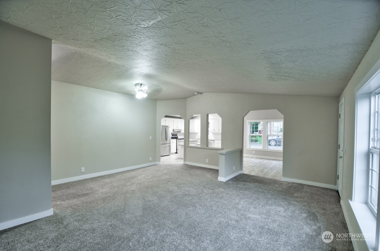 27 South Gee Creek Loop Ridgefield, WA 98642 - Photo 4 of 26 an empty room with fireplace and window
