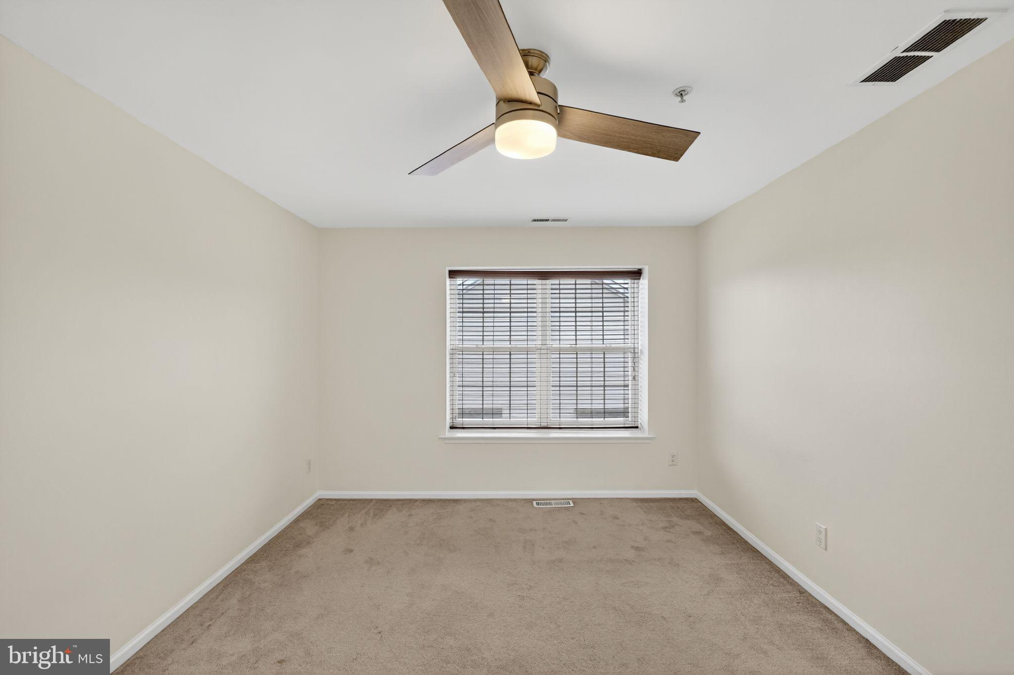1404 Wharton Road Mount Laurel, NJ 08054 - Photo 15 of 30 an empty room with a window and a ceiling fan