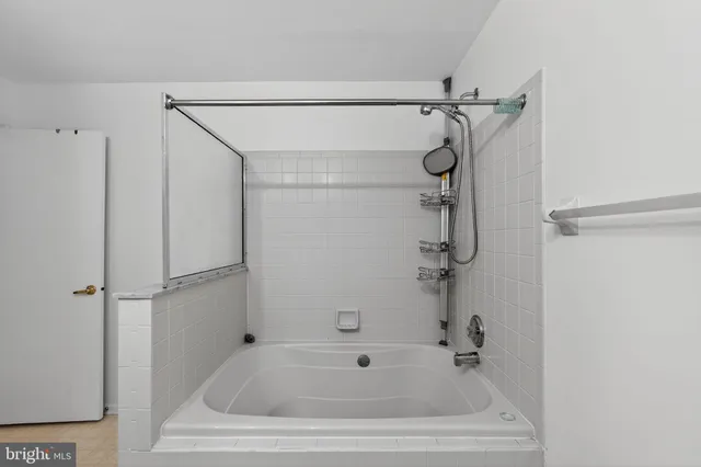 a bathroom with a shower and a bath tub