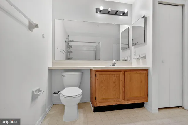 a bathroom with a sink a toilet and a mirror