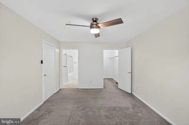 a view of an empty room with a ceiling fan