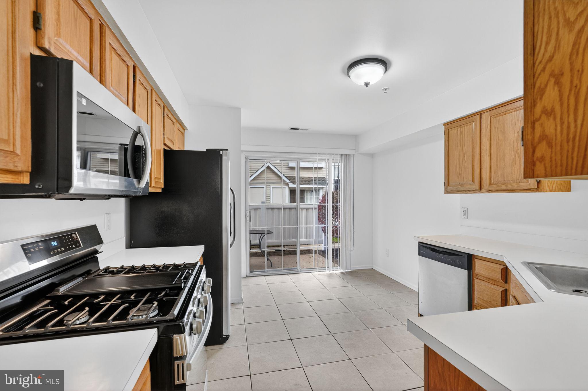 1404 Wharton Road Mount Laurel, NJ 08054 - Photo 7 of 30 a kitchen with stainless steel appliances granite countertop a stove a sink and a microwave