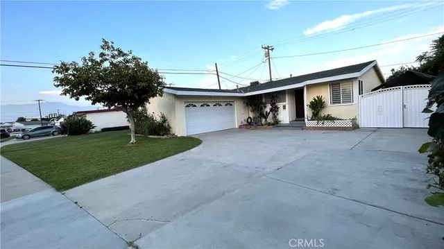 a view of a house with a yard and garage