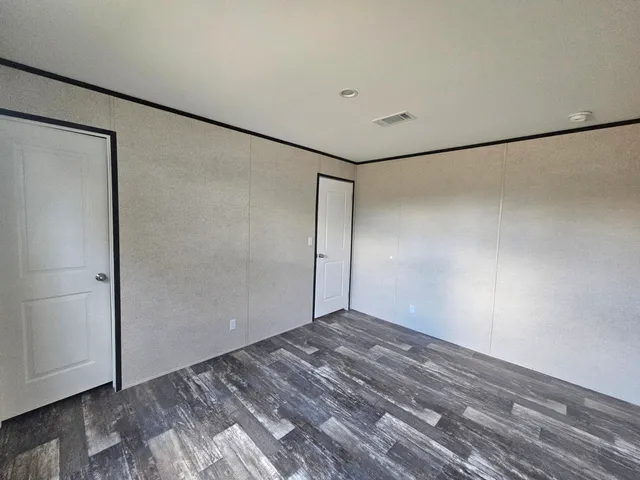 a bathroom with a granite countertop toilet a sink and a mirror