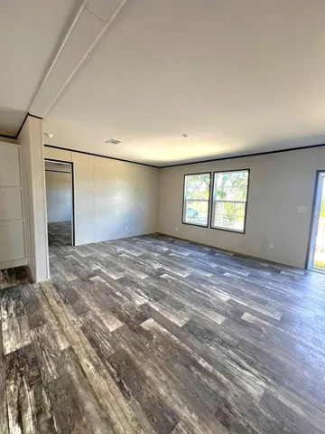 a view of a kitchen with microwave and windows