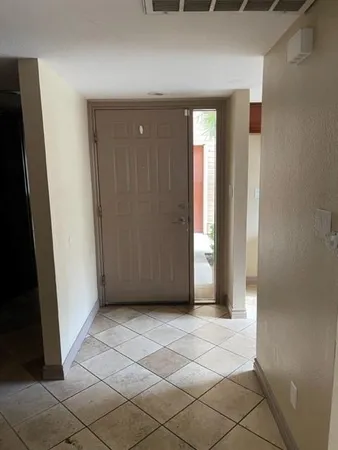 a view of a hallway with a chandelier