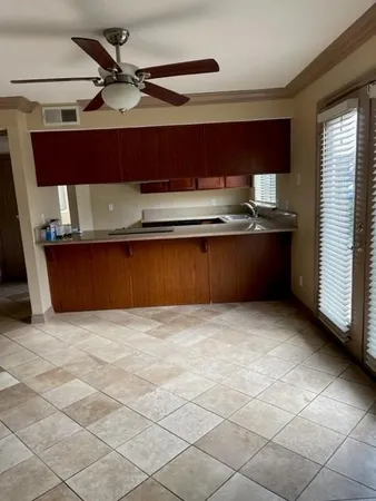 a view of a kitchen with a sink and cabinets