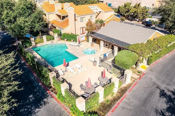an aerial view of a house with yard