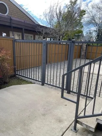 a view of backyard with deck and wooden fence