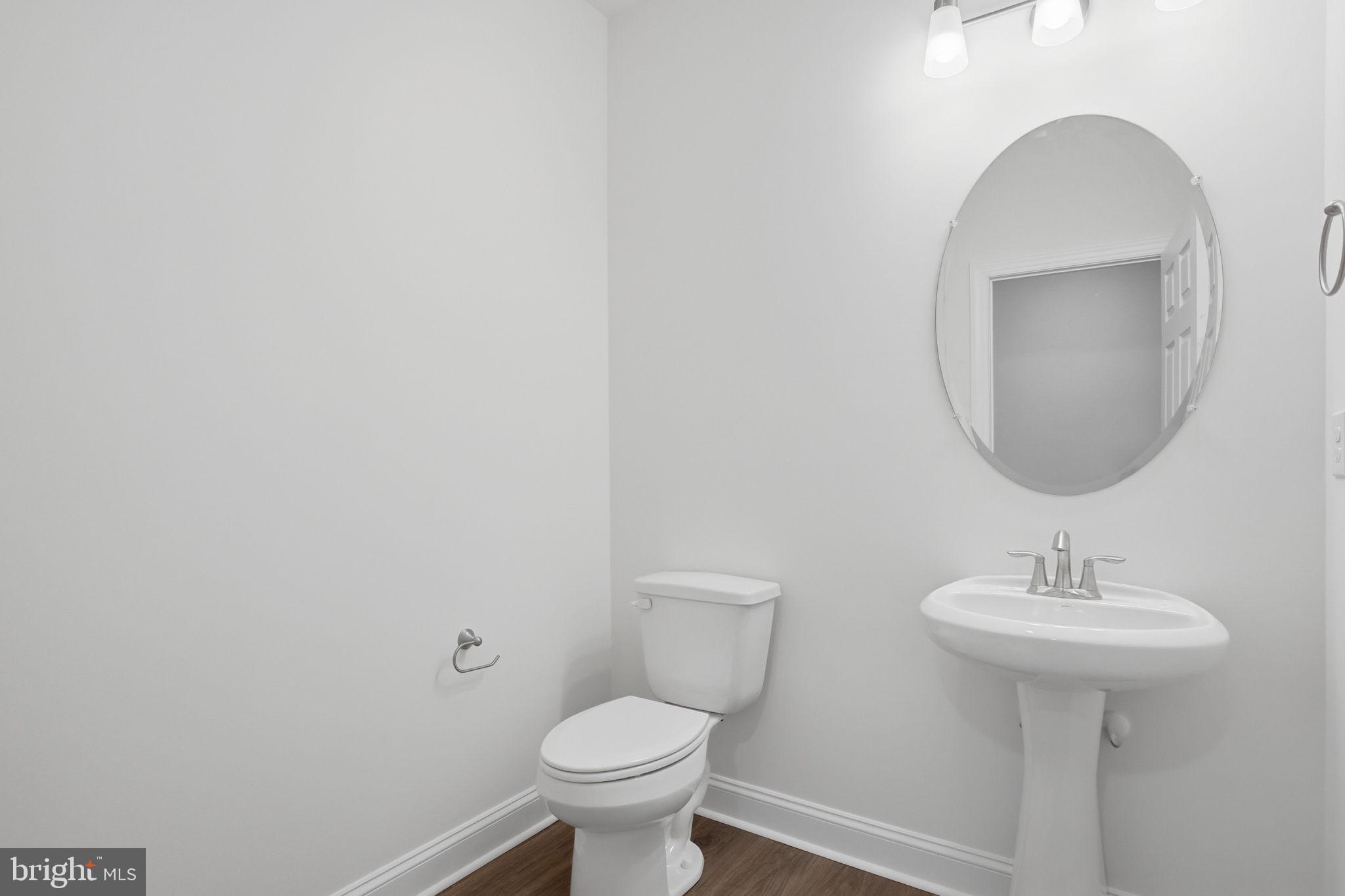 24025 Jerrico Road, Unit 38 Lincoln, DE 19960 - Photo 14 of 32 a bathroom with a sink toilet and a mirror