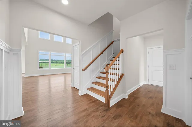 a view of entryway with wooden floor and stairs