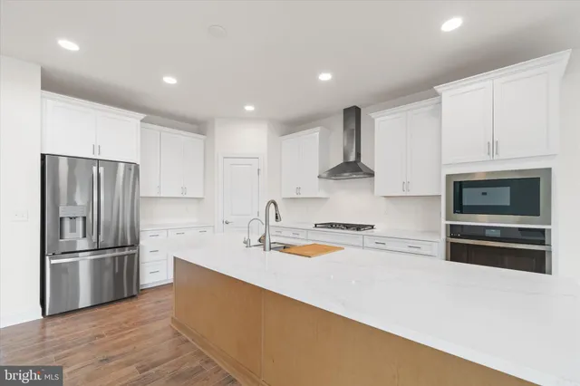 a kitchen with stainless steel appliances granite countertop a sink stove and cabinets