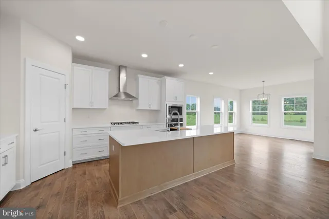 a kitchen with stainless steel appliances a refrigerator sink and microwave