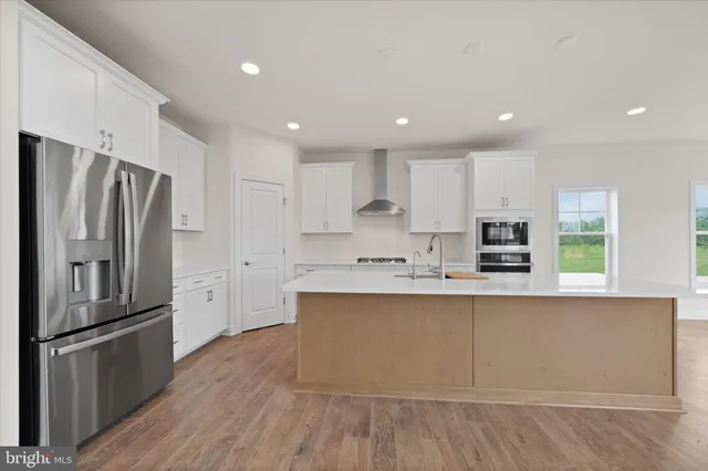 a kitchen with stainless steel appliances a sink stove and cabinets