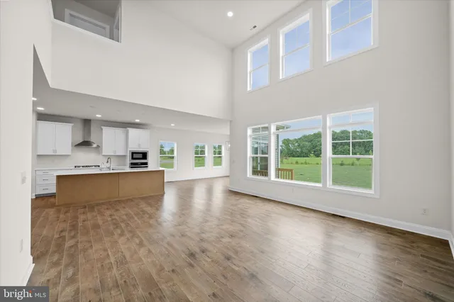 a kitchen with stainless steel appliances granite countertop a refrigerator sink and white cabinets
